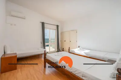 a bedroom with two beds and a mirror at #278 Fonte dos Leoes by Home Holidays in Albufeira