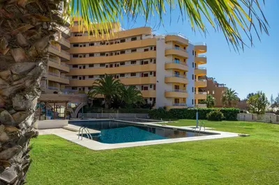 a building with a swimming pool in front of a building at 2 Bed-Sleeps 4-Vilamoura Beach-Pool-Spa-Balcony in Quarteira