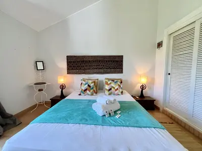 a bedroom with a bed with a stuffed elephant on it at Vilamoura Sunny Garden With Pool by Homing in Vilamoura