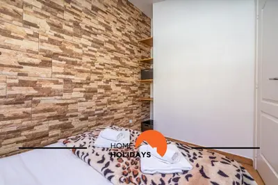 a room with a bed with a brick wall at #288 Vivenda 3 Palmeiras 57 by Home Holidays in Albufeira
