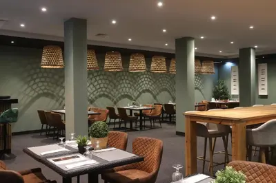 a dining room with tables and chairs and tablesktop at Albufeira Lounge Hotel in Albufeira