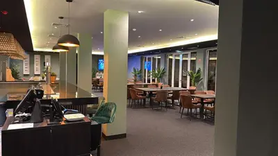 a restaurant with tables and chairs in a cafeteria at Albufeira Lounge Hotel in Albufeira