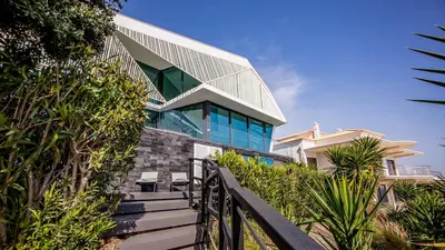a house with a staircase leading up to a building at Algarve Villa for Contemporary Design & Sea Views in Albufeira