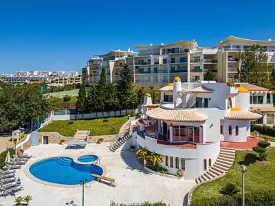 a large house with a swimming pool and a resort at Villa Atlantida by Atlantic Places in Albufeira