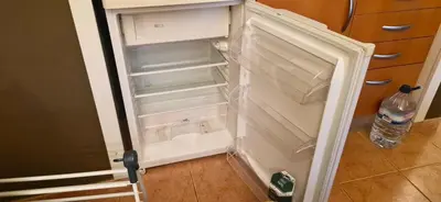 an empty refrigerator with its door open in a kitchen at Studio on Maria Luisa Beach Wifi Parking Swimming Pool in Olhos de Água
