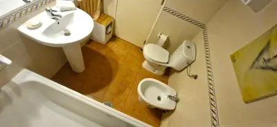 a bathroom with a toilet and a sink at Studio on Maria Luisa Beach Wifi Parking Swimming Pool in Olhos de Água