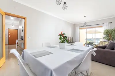 a living room with a couch and a tv at BnB Homes White Rose Garden Apartment with 2 Terraces & 2 Swimming Pools in Albufeira