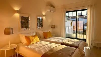 a bedroom with a bed and a large window at Noly by Check-in Portugal in Albufeira