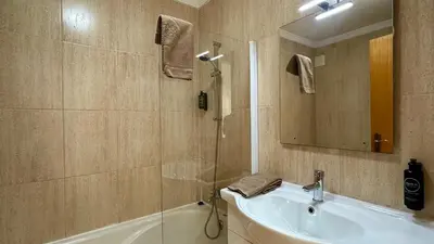 a bathroom with a sink and a shower with a mirror at Noly by Check-in Portugal in Albufeira