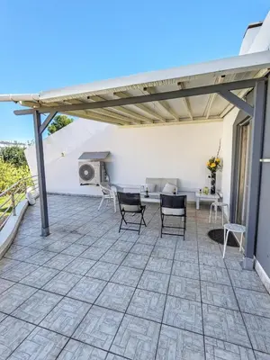 a patio with chairs and a table on a building at Villa Quintaloes, 5 mins from Old Town Albufeira in Albufeira