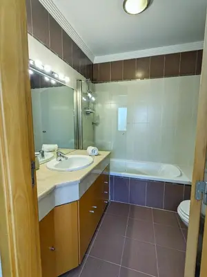 a bathroom with a sink and a tub and a toilet at Villa Quintaloes, 5 mins from Old Town Albufeira in Albufeira