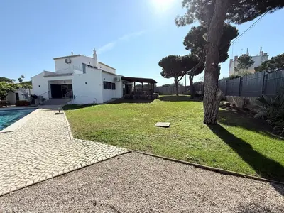a living room with two couches and a table at Villa Oasis 4-Bedroom Retreat with Pool in Vilamoura in Quarteira