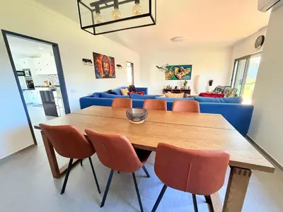 a bedroom with a large green bed with a window at Villa Oasis 4-Bedroom Retreat with Pool in Vilamoura in Quarteira