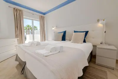 a bedroom with two beds with towels on them at Ocean Vista Retreat with Beach & Pool Access by Drago Rentals in Albufeira