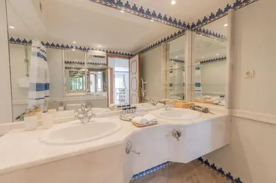 a bathroom with two sinks and a large mirror at Ocean Vista Retreat with Beach & Pool Access by Drago Rentals in Albufeira