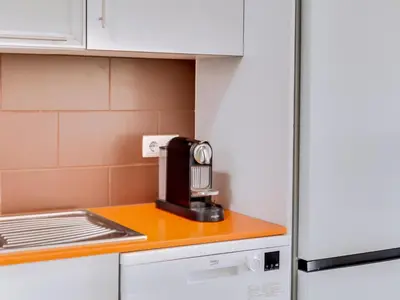 a kitchen with a coffee maker on a counter at AL - Apartamento Canto do Mar frente à praia in Quarteira