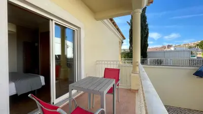 a porch with a table and chairs on a balcony at Sunshine by Check-in Portugal in Albufeira