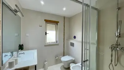 a bathroom with a shower and a toilet and a sink at Sunshine by Check-in Portugal in Albufeira
