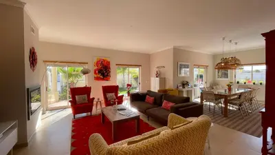 a living room with a couch and chairs and a table at Sunshine by Check-in Portugal in Albufeira