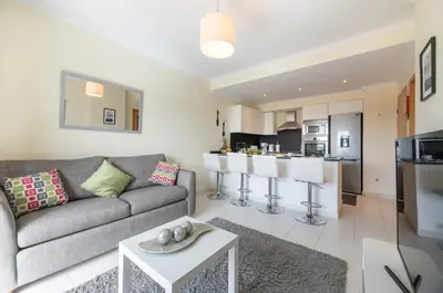 a living room with a couch and a kitchen at Vista Das Ondas 308 By RS in Olhos de Água