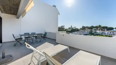 a balcony with a table and chairs and a view at Balaia Project by LovelyStay in Olhos de Água