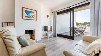 a living room with a couch and a fireplace at Balaia Project by LovelyStay in Olhos de Água