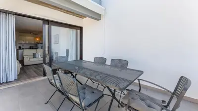 a dining room with a table and chairs at Balaia Project by LovelyStay in Olhos de Água