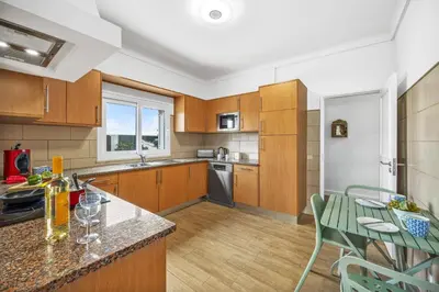 a kitchen with wooden cabinets and a counter top at Villa Domus Vini by Villa Plus in Guia