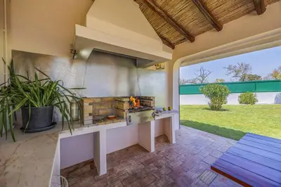 an outdoor kitchen with a fireplace in a patio at Villa Domus Vini by Villa Plus in Guia