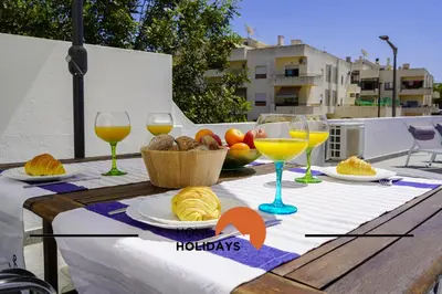 a table with glasses of wine and food on it at #241 Old Town - Casa de Albufeira 1 by Home Holidays in Albufeira