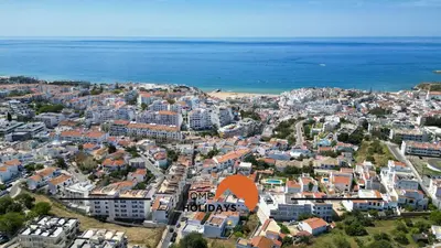 an aerial view of a city with an orange arrow at #241 Old Town - Casa de Albufeira 1 by Home Holidays in Albufeira