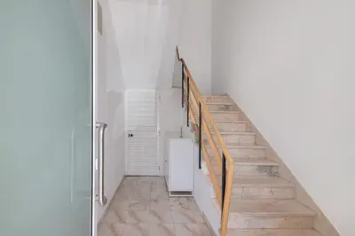 a staircase in a home with white walls at Refúgio Estrela do Mar in Quarteira