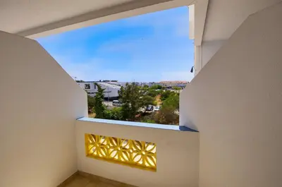 a room with a window with a view of a city at 3 Bed Vacation home in Quarteira in Quarteira