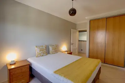 a bedroom with a large bed and two lamps at 3 Bed Vacation home in Quarteira in Quarteira