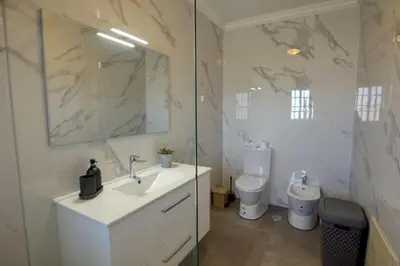 a bathroom with a sink and a toilet at 3 Bed Vacation home in Quarteira in Quarteira