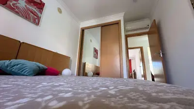a bedroom with a bed with a headboard and a mirror at Apartment Josefa in Albufeira