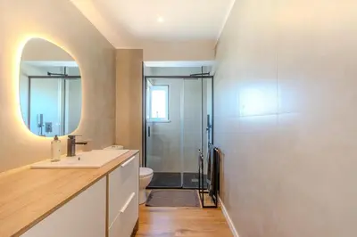 a bathroom with a sink and a toilet and a mirror at Galé Beach Studio - Albufeira - Sea View in Guia