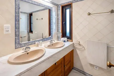a bathroom with two sinks and a mirror at Villa Coral by OCvillas in Albufeira