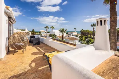 a balcony with a view of the ocean at Villa Coral by OCvillas in Albufeira