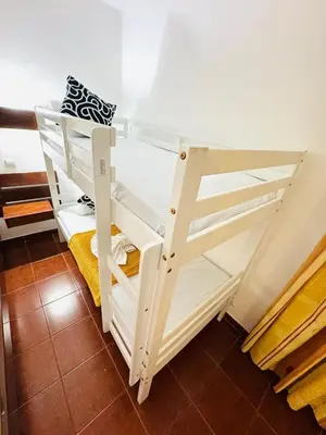 a bunk bed room with white bunk beds at Resort Albufeira Praia Oura in Albufeira