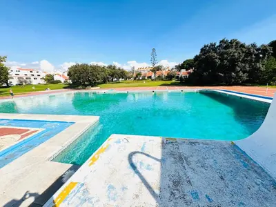 an empty swimming pool with blue water at Resort Albufeira Praia Oura in Albufeira