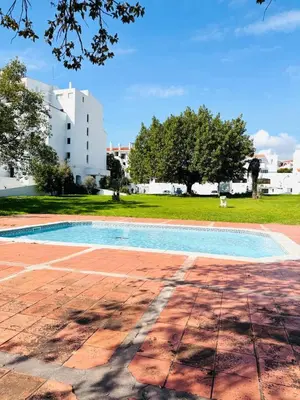 an empty swimming pool with a building in the background at Resort Albufeira Praia Oura in Albufeira