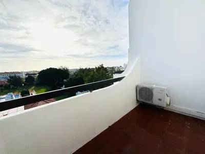a balcony with a air conditioner on a white wall at Resort Albufeira Praia Oura in Albufeira