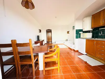 a kitchen with a table and chairs in a room at Resort Albufeira Praia Oura in Albufeira