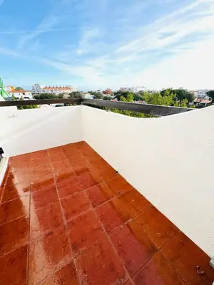 a balcony with a white wall and a tile floor at Resort Albufeira Praia Oura in Albufeira