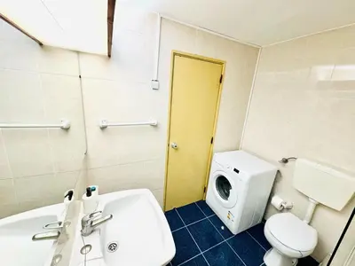 a bathroom with a white sink and a toilet at Resort Albufeira Praia Oura in Albufeira