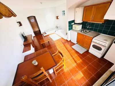 an overhead view of a kitchen with a table and chairs at Resort Albufeira Praia Oura in Albufeira