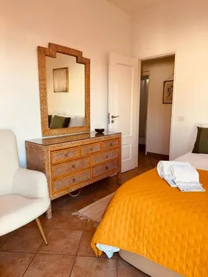 a bedroom with a dresser with a mirror and a bed at Cosy 3 bed Apartment Albufeira Old town in Albufeira