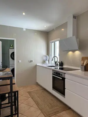 a kitchen with a sink and a stove top oven at Cosy 3 bed Apartment Albufeira Old town in Albufeira