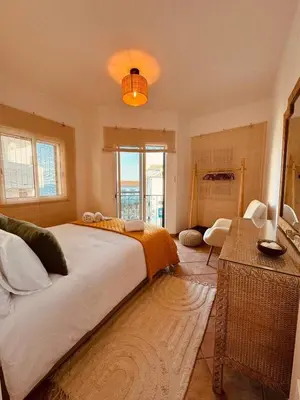 a bedroom with a large bed and a window at Cosy 3 bed Apartment Albufeira Old town in Albufeira